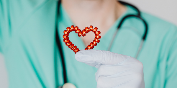 STI medical professional holding red heart shape